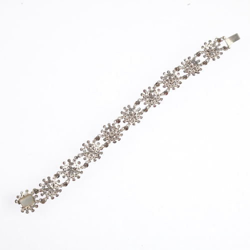 1557 - A Georgian cut-steel flowerhead panel bracelet, 18cm, 14.7g