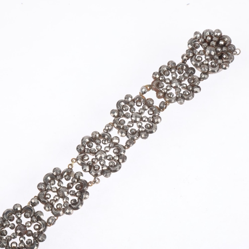 1559 - A Georgian cut-steel flowerhead panel bracelet, 18cm, 30.3g