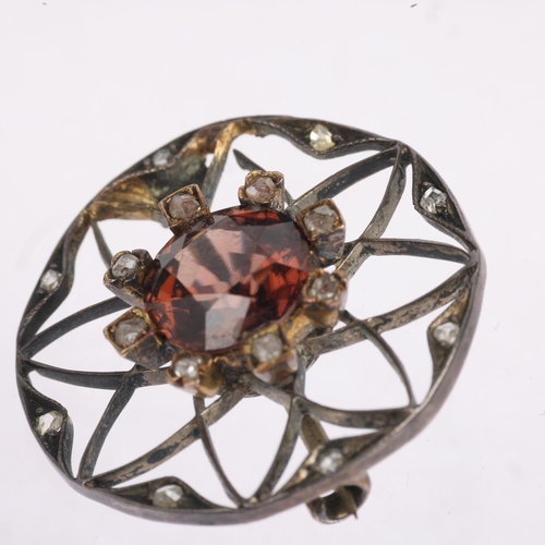 1580 - An Art Nouveau brown zircon and diamond flowerhead openwork brooch, apparently unmarked, 23mm, 3.4g