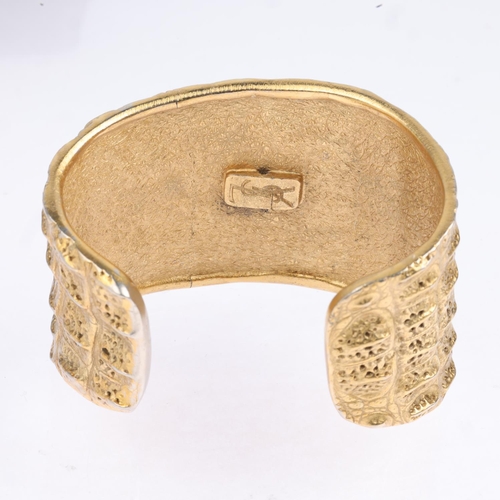 1581 - YVES SAINT LAURENT - a Vintage gilt-metal crocodile cuff bangle, signed YSL, setting height 46.7mm, ... 