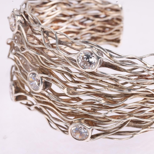 1587 - A sterling silver cubic zirconia wirework cuff bangle, band width 37.4mm, internal circumference 16c... 