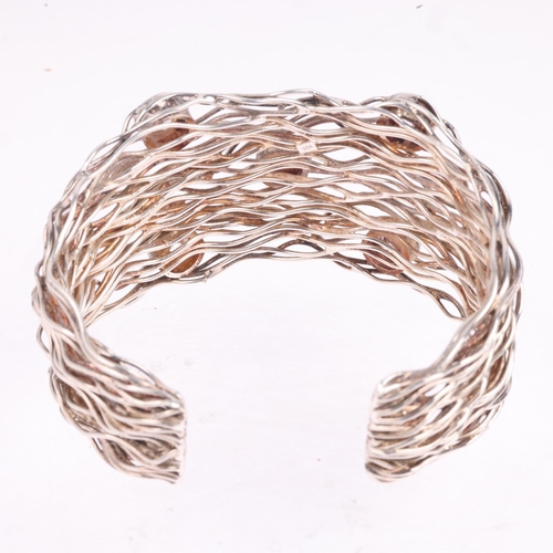 1587 - A sterling silver cubic zirconia wirework cuff bangle, band width 37.4mm, internal circumference 16c... 