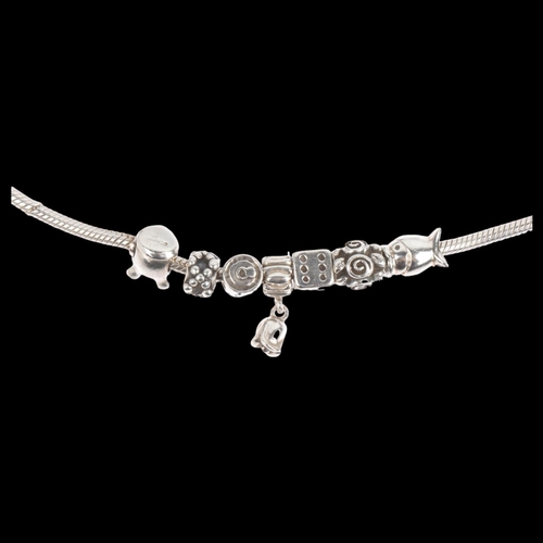 1622 - PANDORA - a sterling silver snake link charm bracelet, with 7 silver charms, 17.5cm, 34.3g