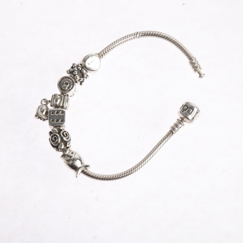 1622 - PANDORA - a sterling silver snake link charm bracelet, with 7 silver charms, 17.5cm, 34.3g