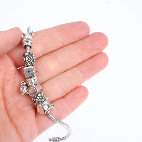 1622 - PANDORA - a sterling silver snake link charm bracelet, with 7 silver charms, 17.5cm, 34.3g