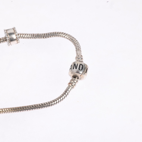 1668 - A sterling silver snake link charm bracelet, in the style of Pandora, with 9 silver charms including... 