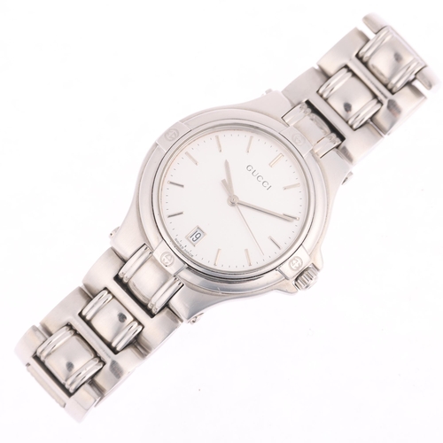 1045 - GUCCI - a stainless steel 9040M quartz calendar bracelet watch, silvered dial with baton hour marker... 