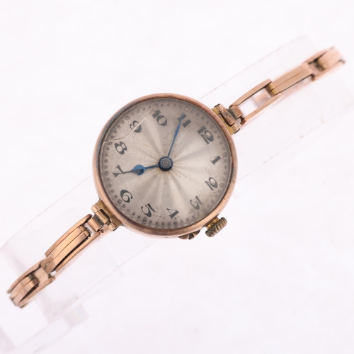 1054 - ROLEX - a First World War Period 9ct rose gold mechanical bracelet watch, silvered engine turned sun... 