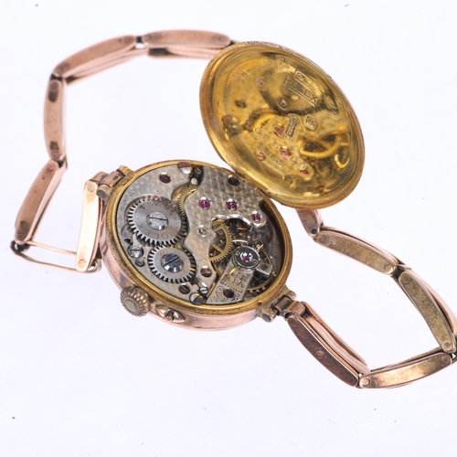 1054 - ROLEX - a First World War Period 9ct rose gold mechanical bracelet watch, silvered engine turned sun... 