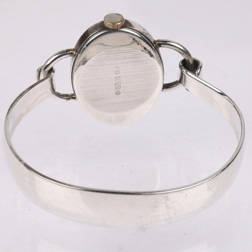 1069 - BIFORA - a lady's German sterling silver mechanical bangle watch, oval silvered dial with Arabic num... 