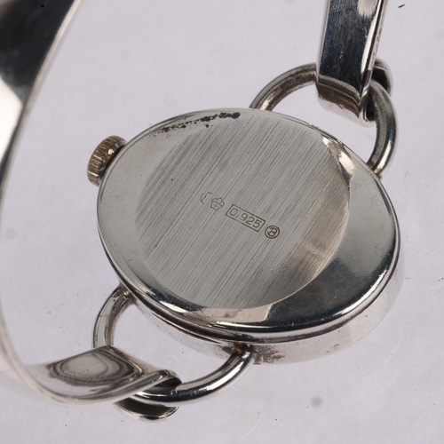 1069 - BIFORA - a lady's German sterling silver mechanical bangle watch, oval silvered dial with Arabic num... 