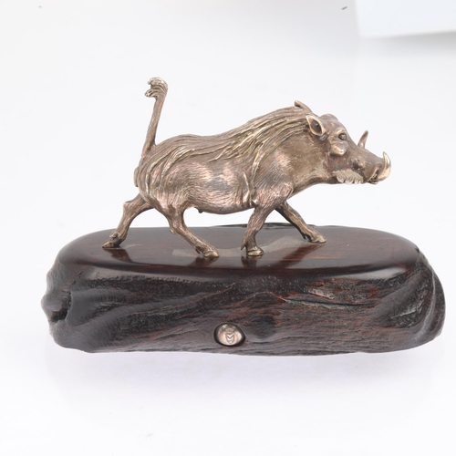 1750 - PATRICK MAVROS (Zimbabwean) - a cast-silver model warthog, realistically modelled on hardwood base, ... 