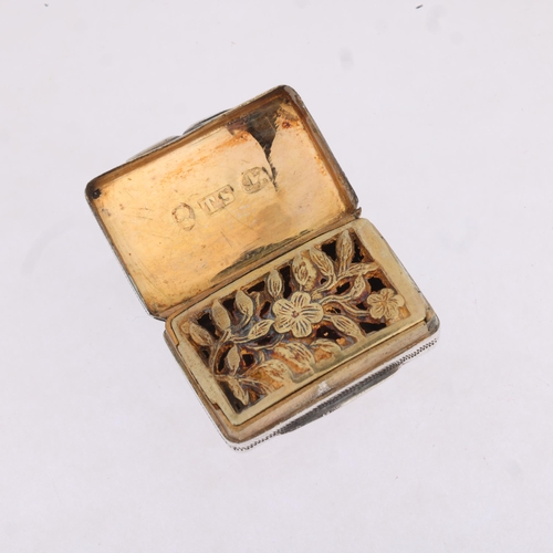 1783 - A George IV silver vinaigrette, maker TS, Birmingham 1822, curved rectangular form, with bright-cut ... 