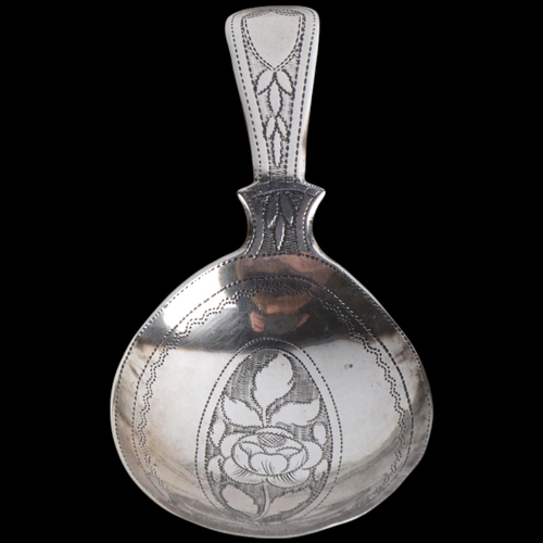 1927 - A George III silver tea caddy spoon, no maker, apparently unmarked, 1812, bright-cut floral engraved... 