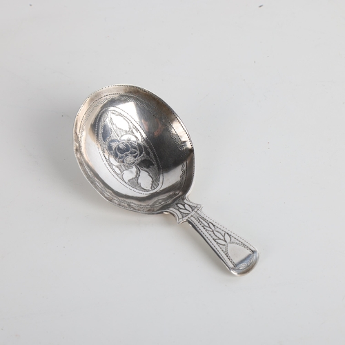 1927 - A George III silver tea caddy spoon, no maker, apparently unmarked, 1812, bright-cut floral engraved... 