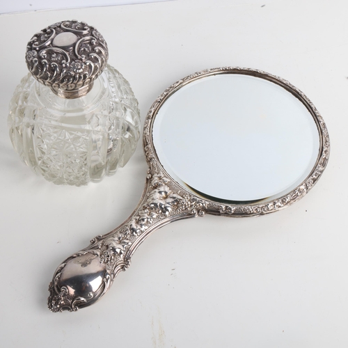 1936 - An Edwardian silver dressing table hand mirror, Birmingham 1903, and a silver-mounted glass scent bo... 