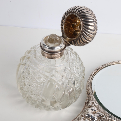 1936 - An Edwardian silver dressing table hand mirror, Birmingham 1903, and a silver-mounted glass scent bo... 