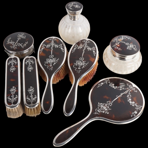 1949 - An Art Deco George V silver and tortoiseshell pique inlaid 8-piece dressing table vanity set, Adie B... 