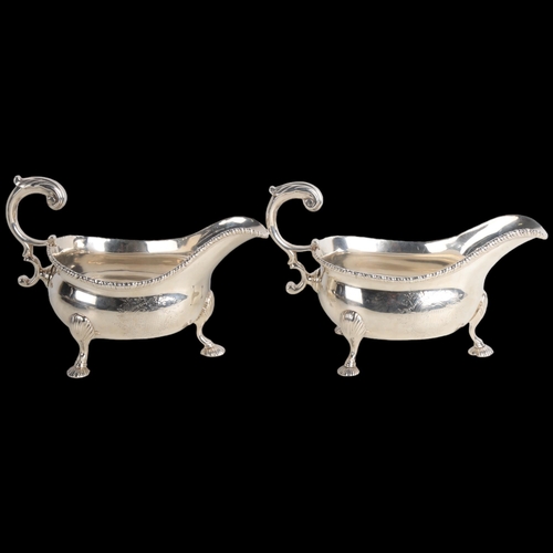 1951 - A fine pair of George II silver sauce boats, Robert Innes, London 1751, gadrooned rims with scrolled... 