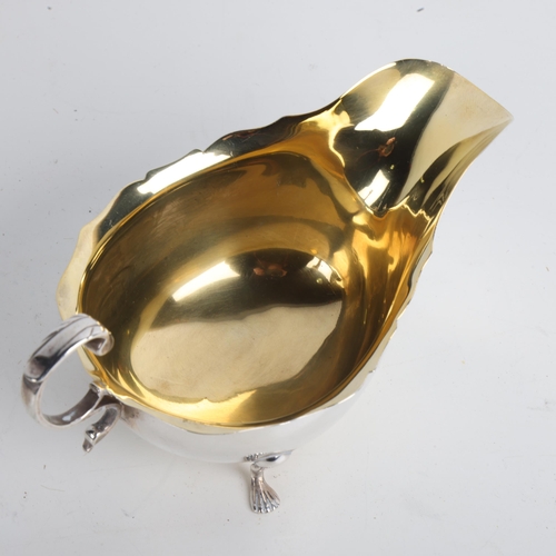 1952 - An Edwardian silver sauce boat, Wilson & Gill, London 1903, C-shaped handle with gilt interior, 15cm... 