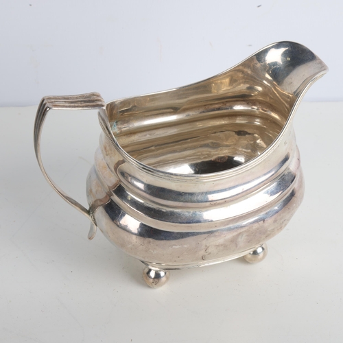 1954 - A George III silver cream jug, indistinct maker, London 1779, bulbous form with reeded rim and bun f... 