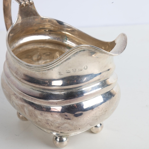 1954 - A George III silver cream jug, indistinct maker, London 1779, bulbous form with reeded rim and bun f... 