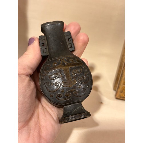 73 - A miniature Chinese patinated bronze vase, with relief cast decoration, height 10cm