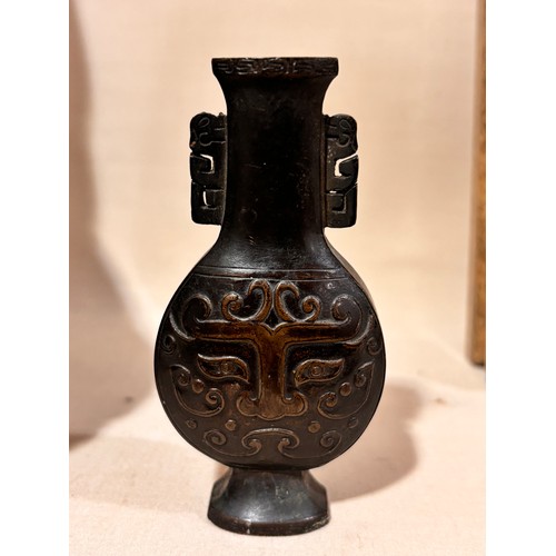 73 - A miniature Chinese patinated bronze vase, with relief cast decoration, height 10cm