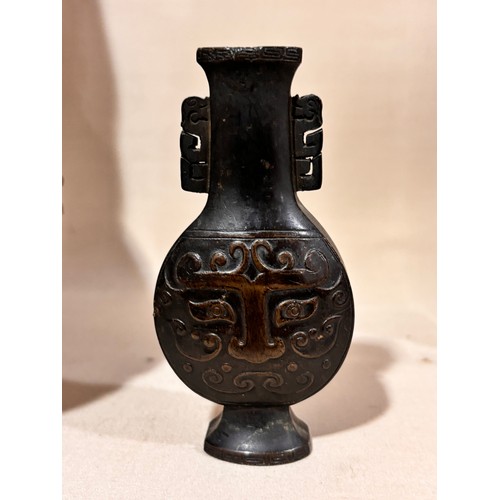 73 - A miniature Chinese patinated bronze vase, with relief cast decoration, height 10cm