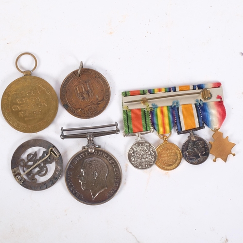 124 - A group of miniature First and Second World War medals, a First World War medal and Defence medal na... 