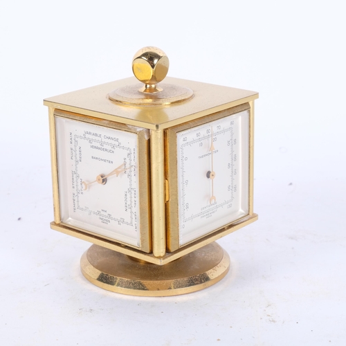 127 - Neiman-Marcus, a mid-century gilt desk clock and weather compendium, on revolving stand, Swiss-made ... 