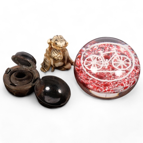 135 - A French glass paperweight, with bicycle motif, a travelling metal inkwell, and a carved staghorn ne... 