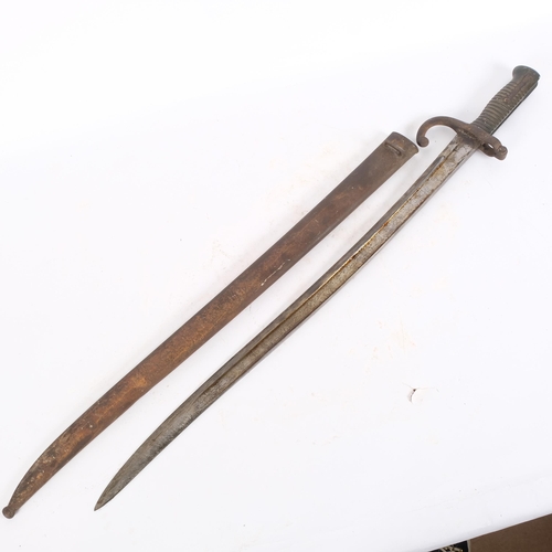 73 - A French 1866 pattern Chassepot bayonet and scabbard, with script along the top edge, blade length 5... 