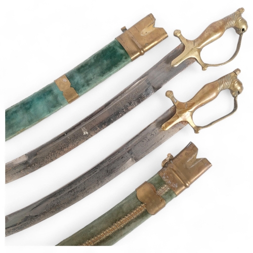 74 - A pair of Indian brass-mounted short swords, engraved blades and velvet-covered scabbards, blade len... 