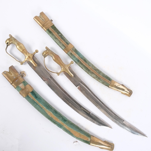 74 - A pair of Indian brass-mounted short swords, engraved blades and velvet-covered scabbards, blade len... 