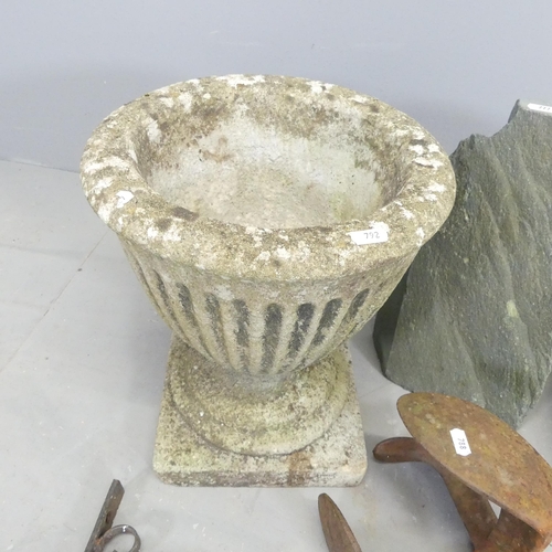 2619 - A weathered concrete garden urn with fluted decoration, 31x37cm, a pair of cobbler's anvils, etc.