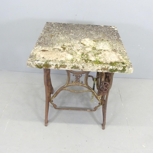 2627 - A weathered concrete garden table on cast iron treadle sewing machine base. 60x79x60cm.