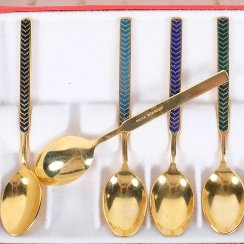 161 - A set of Meka, Danish, gilded spoons, with hand enamelled decoration, original box