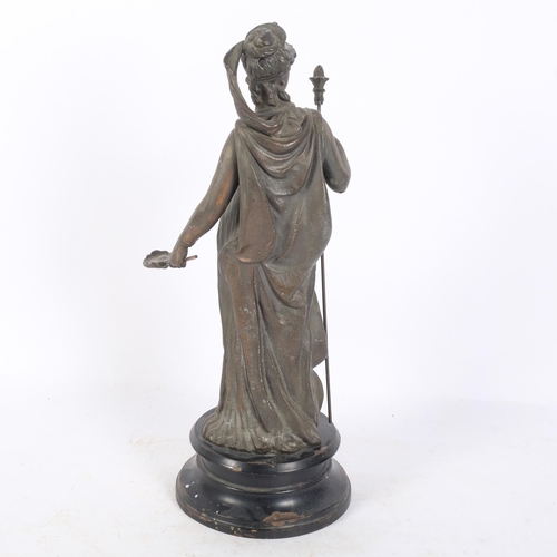 234 - A patinated spelter figure of a Grecian lady, on a painted black metal stand, H35cm