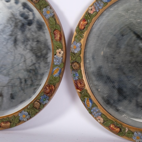 341 - A pair of early 20th century circular Barbola bevel-edge wall mirrors, diameter 36cm