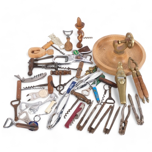 426 - Antique and other corkscrews, a nut dish, nutcrackers, and bottle openers