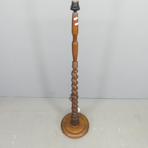 2651 - An oak standard lamp, with spiral turned column on platform base. Height to bayonet 143cm.