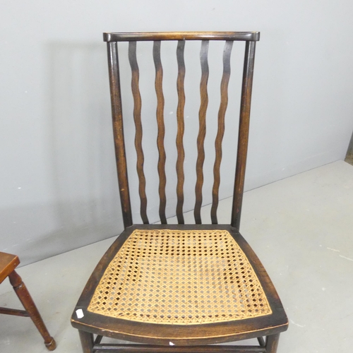 2660 - An Edwardian Arts & Crafts side chair, and a low wavy back cane-seated chair.