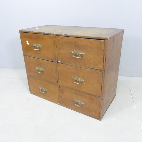 2667 - An early 20th century stained pine bank of six drawers. 61x49x31cm.