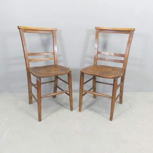 2669 - A pair of antique elm-seated chapel chairs.