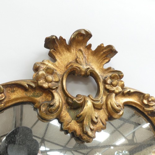 59 - A gilt-framed Italian baroque style mirror. Height 73cm.