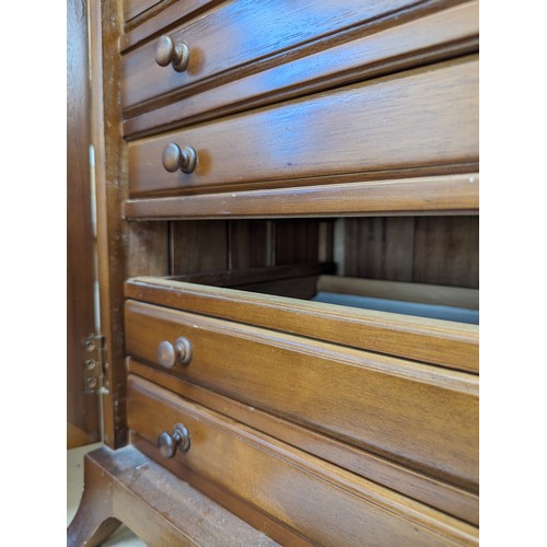 48 - A modern walnut table-top collector's cabinet, the panelled doors opening to reveal 7 fitted drawers... 