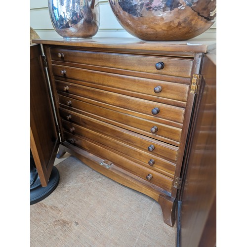 48 - A modern walnut table-top collector's cabinet, the panelled doors opening to reveal 7 fitted drawers... 