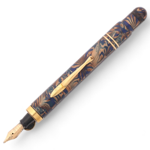 561 - A Pullman blue and gilt marbled fountain pen with 14k nib and gilt mounts, with push action pop up n... 