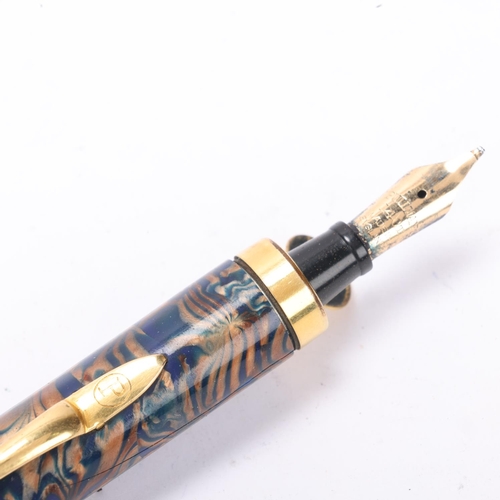 561 - A Pullman blue and gilt marbled fountain pen with 14k nib and gilt mounts, with push action pop up n... 